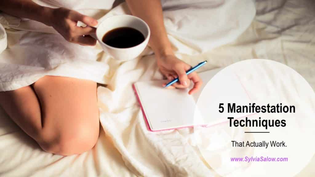 woman sitting on bed writing down into a journal and drinking a cup of coffee